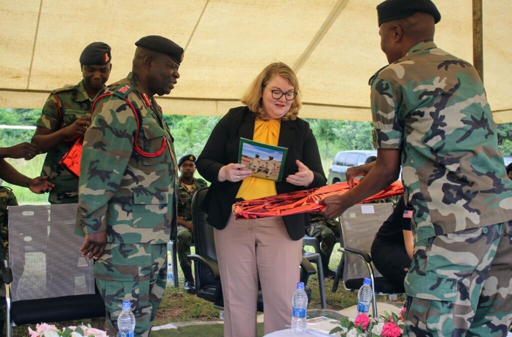US Embassy’s Charge D’Affaires Amy Diaz (C) getting a copy of the magazine from the former Commanding Officer for Changalume Barracks’, Major Exwino Manjawila (R)